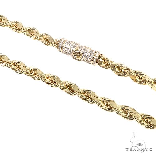 14k yellow gold 7mm diamond-cut solid rope chain with iced TraxNYC diamond logo lock clasp, flat lay view
