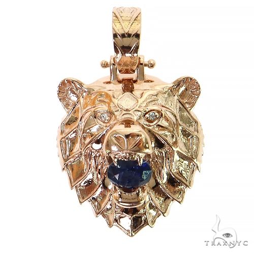 14K rose gold grizzly bear pendant with blue gemstone eye detail and textured design