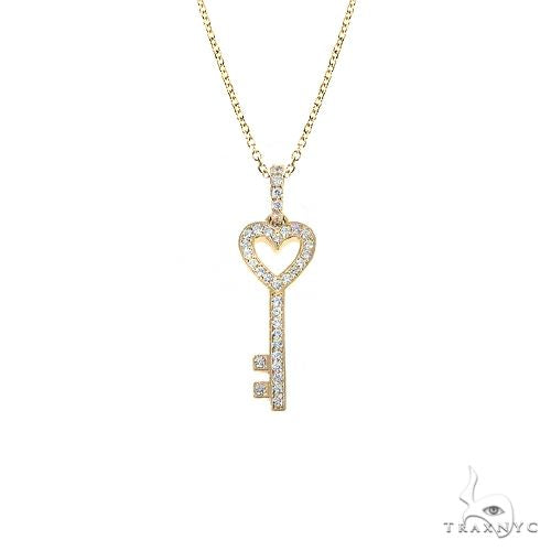 14K gold heart and key diamond pendant set — front view showing round-cut diamond accents on both pieces