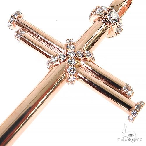14K rose gold cross pendant with diamond accents on nail-inspired design