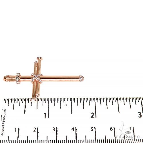 14K rose gold cross pendant with nail design and diamond accents, measuring about 2 inches long