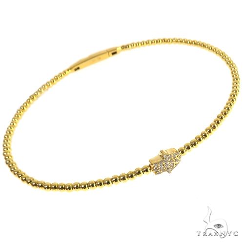 Hamsa bangle bracelet in 14k yellow gold with round-cut diamond accents, front-facing view