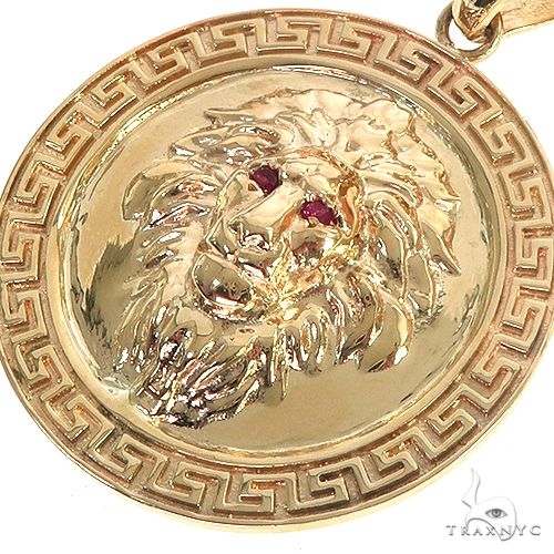 14K yellow gold round lion head pendant with red gemstone eyes and Greek key border design