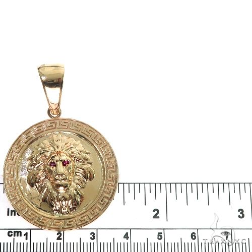 14K yellow gold lion pendant with ruby eyes and Greek key border design