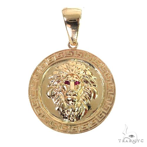 14K yellow gold lion head pendant with ruby eyes and engraved circular frame