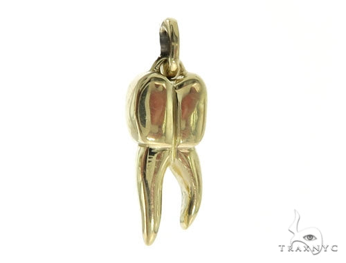 14K yellow gold small tooth pendant with polished finish and bail loop for chain