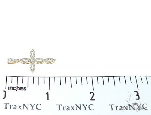 14K yellow gold twisted cross pendant with diamond accents, measuring just under 1 inch