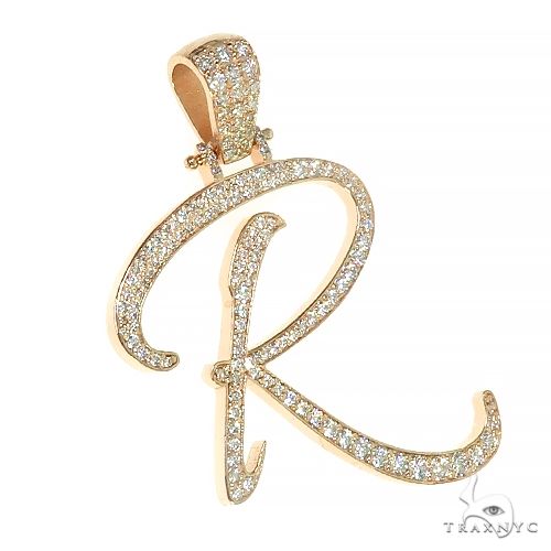 14k yellow gold diamond-encrusted cursive "R" pendant with a diamond-studded bail