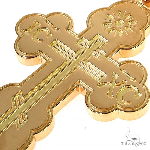 18K yellow gold men's cross pendant with intricate engraved design and polished finish