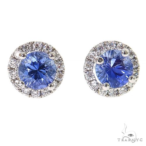 White gold stud earrings with round sapphire centers surrounded by diamond halos