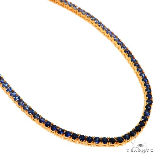 Yellow gold tennis chain with 20 graduated deep blue sapphire gemstones