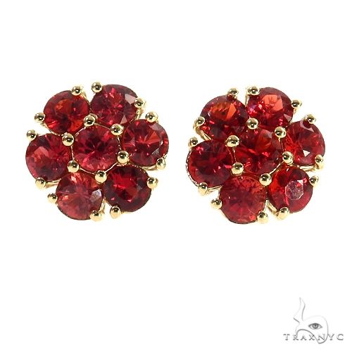 Large flower cluster earrings with red sapphires and diamond accents in a full floral setting