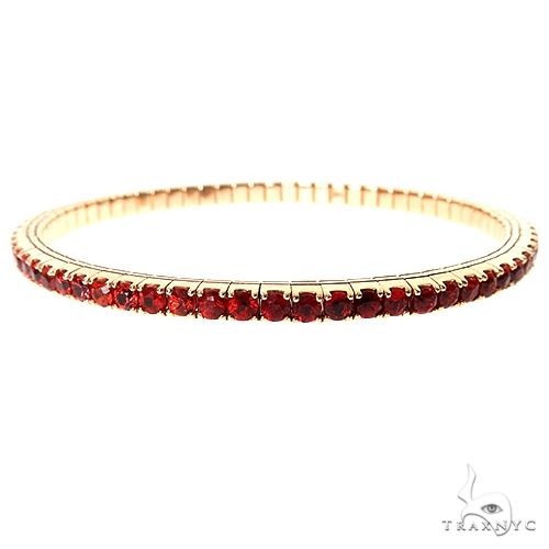 Sapphire stretch bangle bracelet in 14k yellow gold — prong-set fire sapphires in continuous band