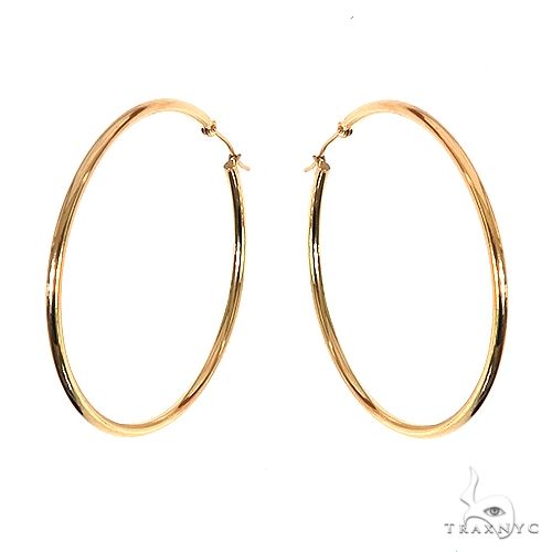 14k yellow gold hoop earrings, 55mm diameter, high-polish finish, angled view