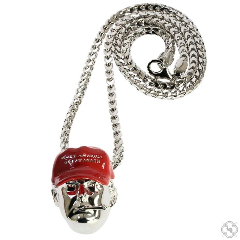 Silver pendant of a face wearing a red "Make America Great Again" hat with a cigar in the mouth