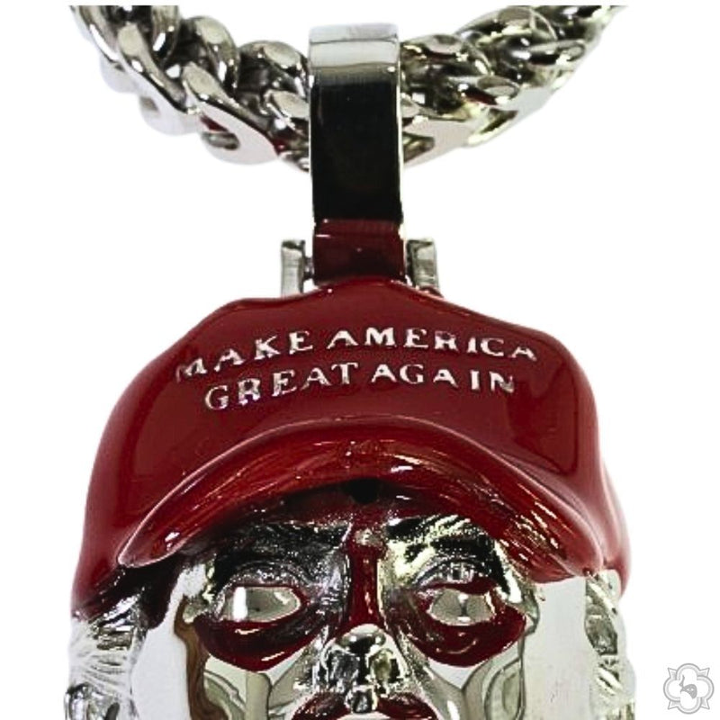 Silver pendant shaped like a face wearing a red "Make America Great Again" hat on a chain