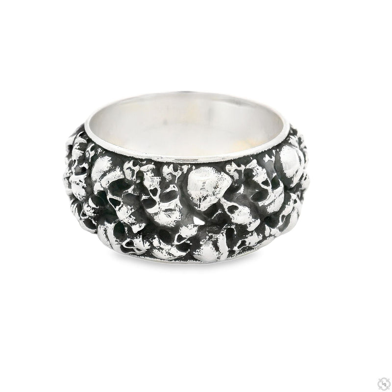 Silver band ring with detailed skull design on thick, textured surface