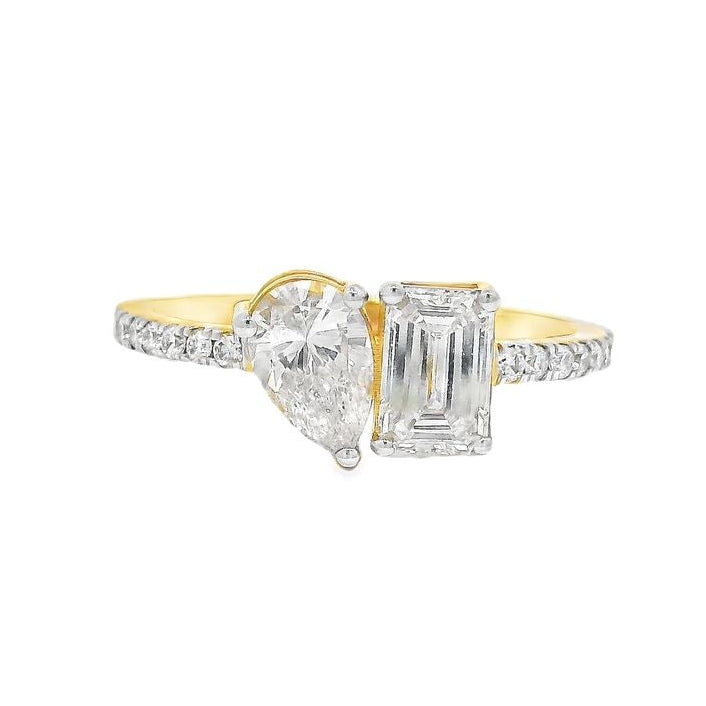 Yellow gold engagement ring with pear-shaped and emerald-cut diamonds on diamond band
