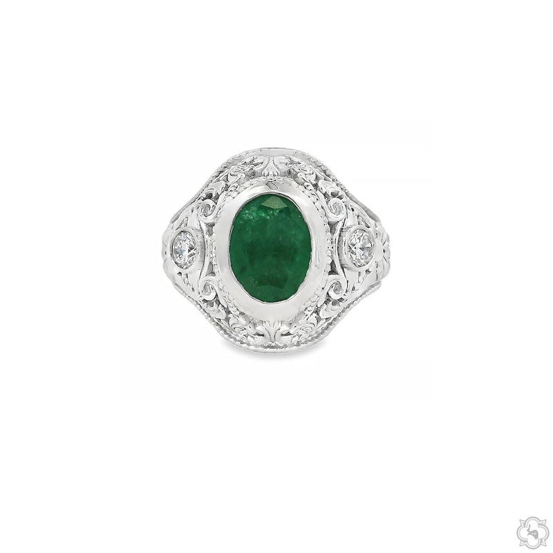 Silver ring with oval green emerald center and intricate filigree detailing