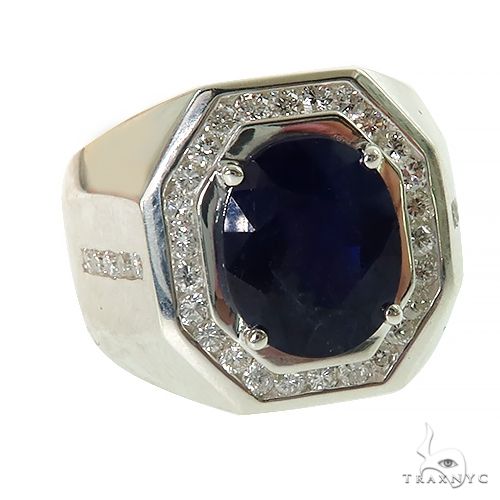 Oval deep blue sapphire ring with silver band and diamond accents in octagonal setting