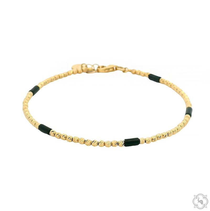 Delicate yellow gold beaded bracelet with small black accents and lobster clasp closure