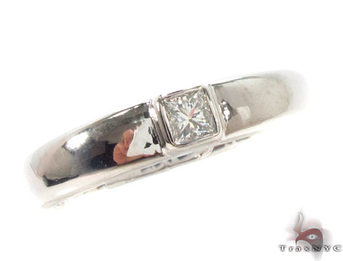 White gold men's wedding band with a bezel-set square-cut center stone