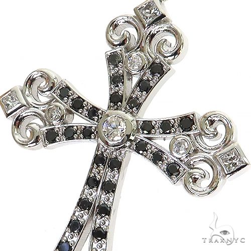 White gold cross pendant with black and white diamonds, intricate scroll design