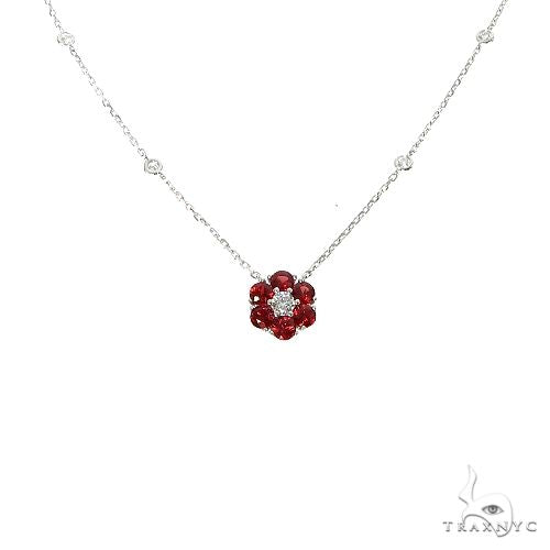 Yellow gold necklace with red sapphire and diamond flower pendant on delicate chain