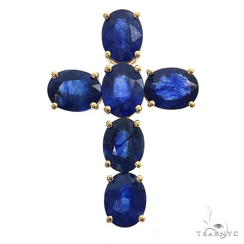 Oval blue sapphire gemstone cross pendant set in yellow gold prongs