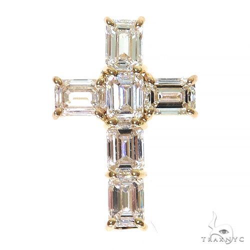 Yellow gold cross pendant with emerald-cut diamonds in a custom celestial design