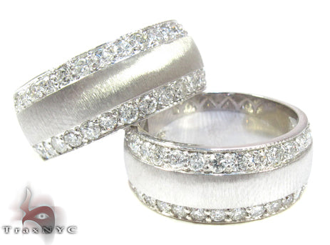 Pair of yellow gold wedding bands with central diamond rows and brushed finish edges