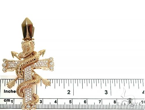 Rose gold cross pendant wrapped by detailed cobra with diamond accents and bail loop