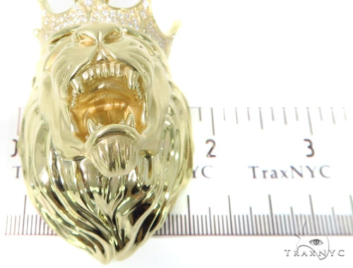 Yellow gold lion head pendant with crown and diamond accents, measuring over 2 inches tall