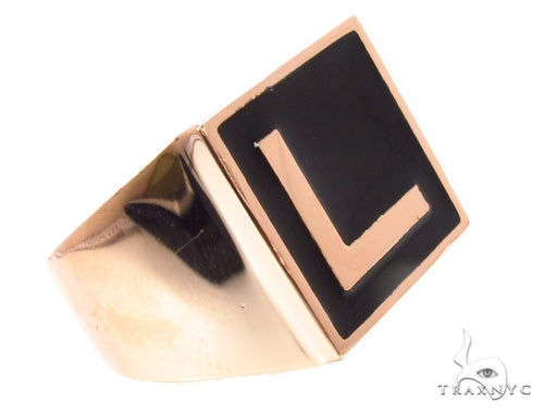 Gold ring with raised L initial over a black enamel square face
