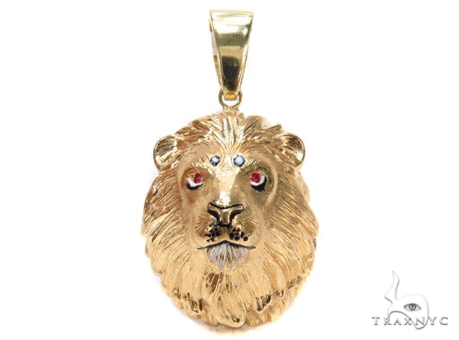 Yellow gold lion head pendant with ruby eyes and detailed mane engraving