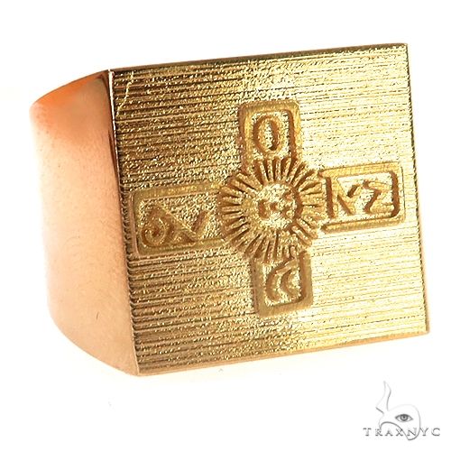 Square yellow gold ring with engraved ornate cross design on textured surface