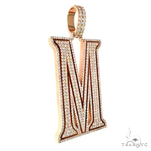 Yellow gold diamond-encrusted initial M pendant with pavé setting and polished edges