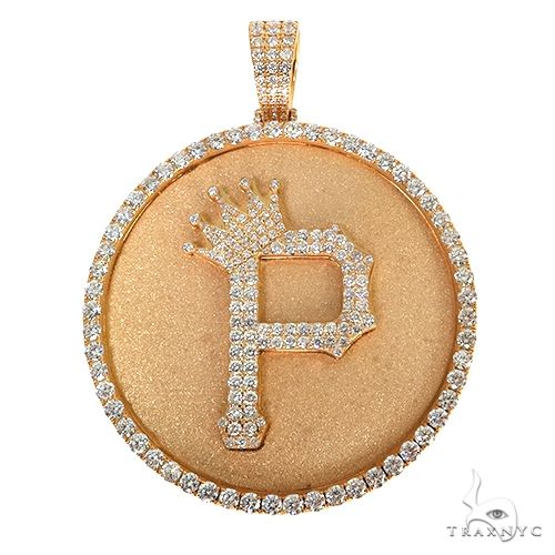 Rose gold round pendant with diamond-studded initial P and crown detail