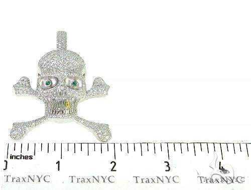Diamond-encrusted skull and crossbones pendant with emerald eyes and gold tooth in white metal