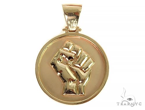 Solid gold pendant with raised clenched fist design on round yellow gold base