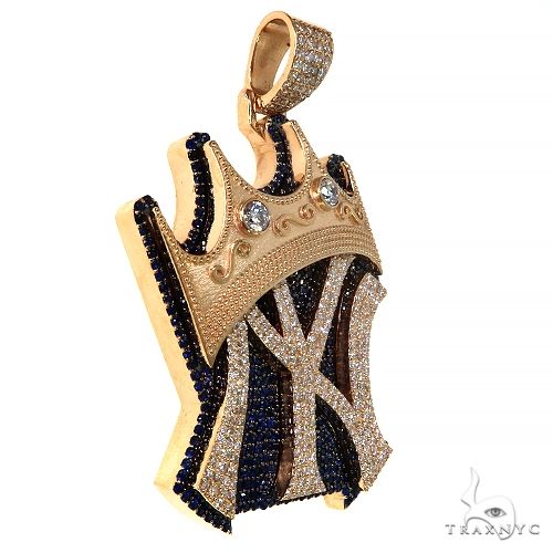 Gold crown pendant with black and white stones forming a stylized Yankee logo
