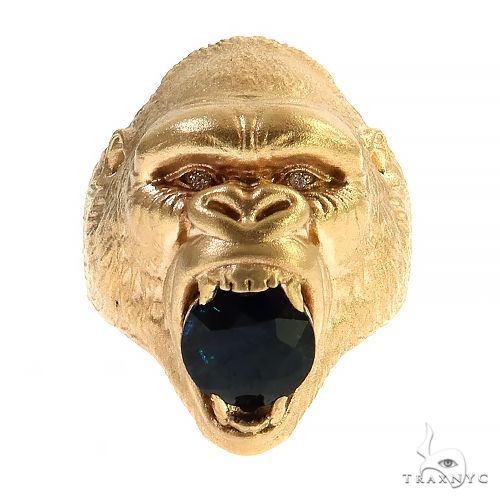 Yellow gold gorilla head ring with dark blue sapphire gemstone in open mouth