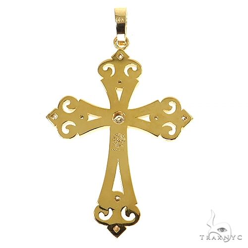 Yellow gold cross pendant with decorative cutouts and small diamond accents