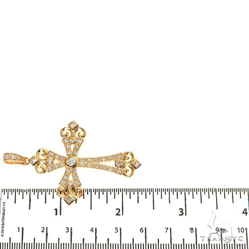 Yellow gold cross pendant with small diamonds and decorative fleur-de-lis ends, 2 inches long