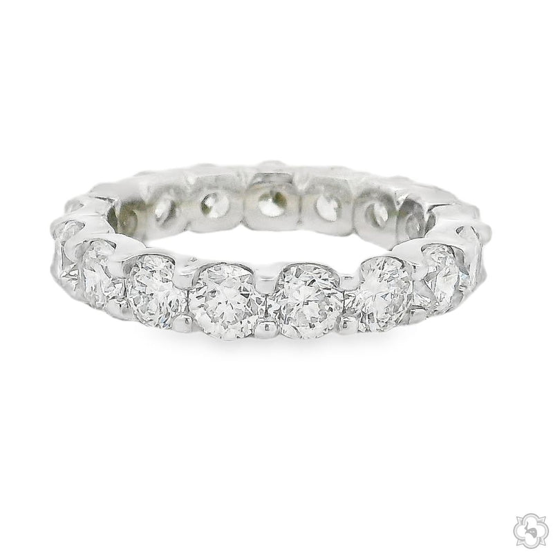 White gold diamond eternity band with round-cut stones encircling the entire ring