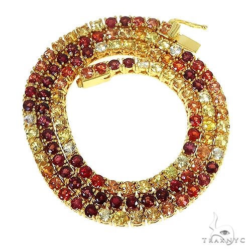 Multi colored gemstone tennis chain with continuous prong-set fire sapphire stones, front-facing flat lay