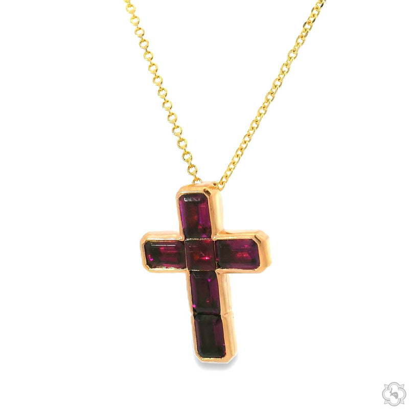 Yellow gold cross pendant with deep red garnet gemstones on delicate chain
