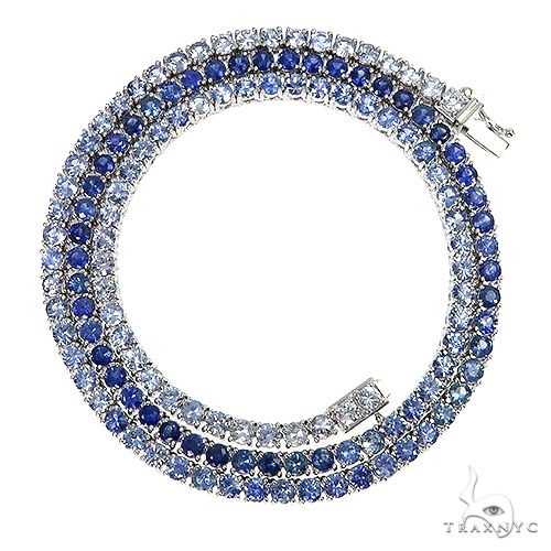 Graduated sapphire tennis chain necklace in white metal with deep blue gemstones