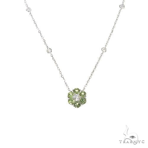 Yellow gold necklace with green sapphire and diamond flower pendant on delicate chain