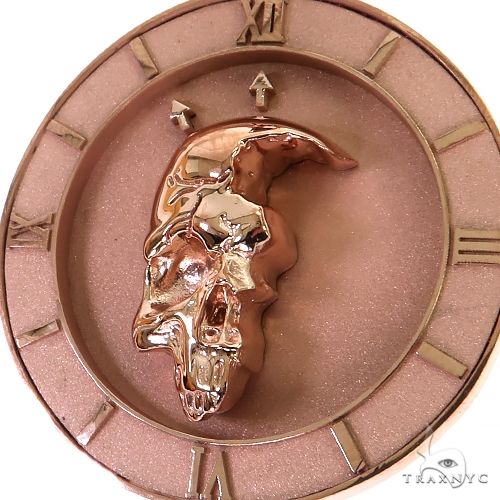 Rose gold half skull pendant with detailed engraved features and polished finish